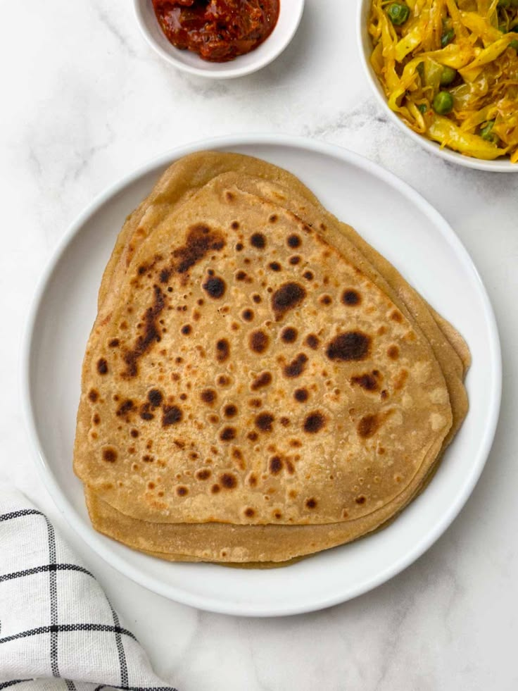 Plain Paratha (2pcs) with Amul butter, Fresh curd, Sweet & Sour Chutney and Mint Chutney/ Garlic Chutney